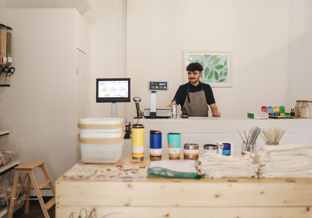 A shop assistant serving at the counter